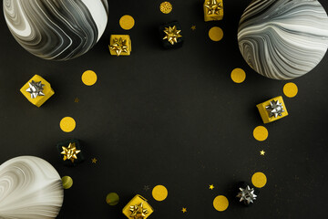 Gift present boxes and confetti on black background with blank space