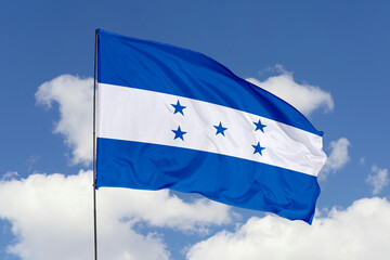 Honduras flag isolated on the blue sky background. close up waving flag of Honduras. flag symbols of Honduras. Concept of Honduras.