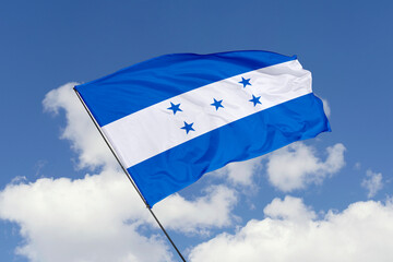Honduras flag isolated on the blue sky background. close up waving flag of Honduras. flag symbols of Honduras. Concept of Honduras.