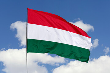 Hungary flag isolated on the blue sky background. close up waving flag of Hungary. flag symbols of Hungary. Concept of Hungary.