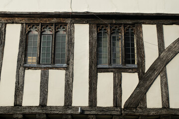Fototapeta na wymiar Close up side of Tudor timber framed cottage house with tall windows at Saffron Walden, England