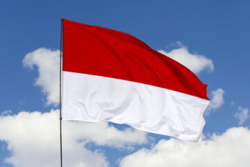 Indonesia flag isolated on the blue sky background. close up waving flag of Indonesia. flag symbols of Indonesia. Concept of Indonesia.