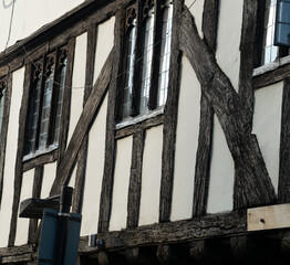 Close up side of Tudor timber framed cottage house with tall windows at Saffron Walden, England