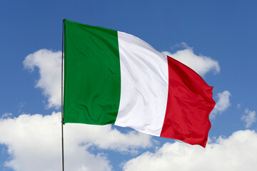 Italy flag isolated on the blue sky background. close up waving flag of Italy. flag symbols of Italy. Concept of Italy.