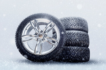 winter studded tires, a set of friction winter wheels with aluminum alloy wheels on a white...