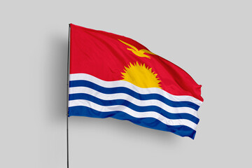 Kiribati flag isolated on the blue sky background. close up waving flag of Kiribati. flag symbols of Kiribati. Concept of Kiribati.