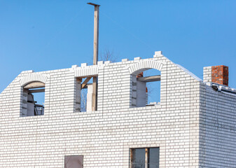 A window in a brick house under construction.