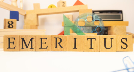 The word Emeritus was created from wooden cubes. Education and career concept.