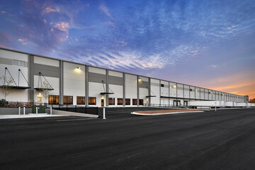 Modern warehouse distribution center at sunset - obrazy, fototapety, plakaty