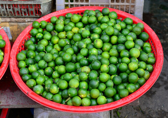 Selling green lemon at market