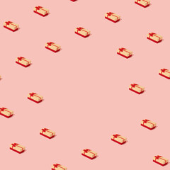 pattern made with cristmas and new year gift box against pastel pink background. modern minimalism with copyspace