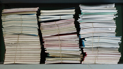  stacks of documents on a shelf © flafabri