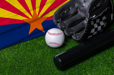 Baseball bat, glove and ball near Arizona flag on green grass background
