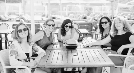 Women best friends sitting in summer cafe on the beach