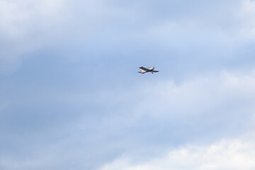 Small private flying airplane yet flying in the sky with cloudy weather.