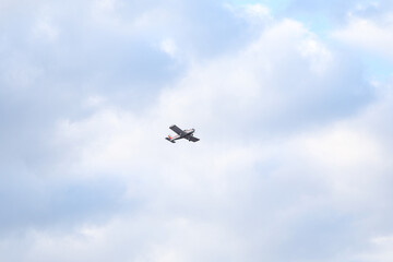 Small private flying airplane yet flying in the sky with cloudy weather.