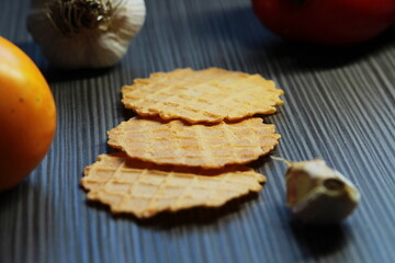 diet waffles on a dark wooden background. Healthy chips close-up.