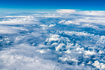 Fototapeta na wymiar Blue and white cloudscape seen from an aircraft in mid-air