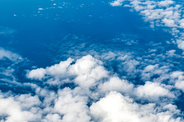 Blue and white cloudscape seen from an aircraft in mid-air