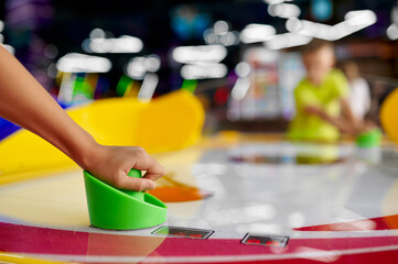 Kids play air hockey in entertainment center
