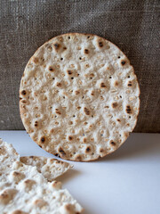 Close-up to round crispbread on white/textile background