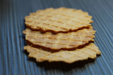 
diet waffles on a dark wooden background. Healthy chips close-up.