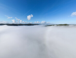 Fototapeta premium Valley fog is a fascinating meteorological phenomenon that forms due to the condensation of water vapor in the air near the earth's surface