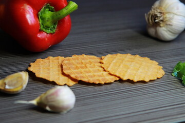 Food photo. Waffles on a dark wooden background with bright vegetables