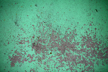 Grunge green colored Wall with cracks and scratches on it. Creative surface paint green colored and wounded background. 