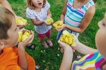 Children eat chips on the street. Selective focus.