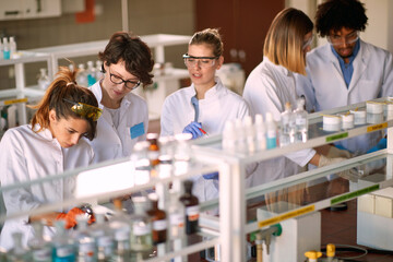 Young students enjoy working in a laboratory. Science, chemistry, lab, people
