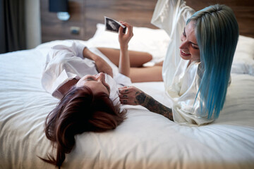 Cheerful lesbian couple sharing a pregnancy test results