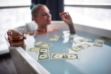 Close up of a hot punk girl taking a bath; Hedonistic lifestyle