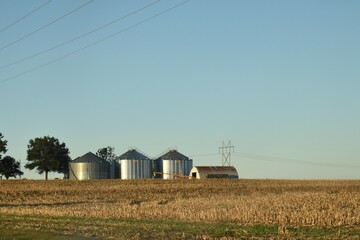 Grain Bins and a Barn in a Field