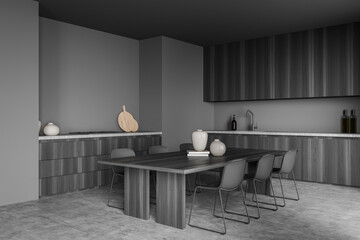 Corner view of modern grey kitchen with dining table