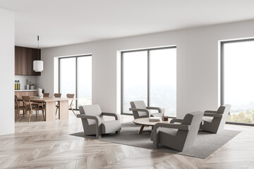 Beige seating area in white panoramic living space with kitchen on background