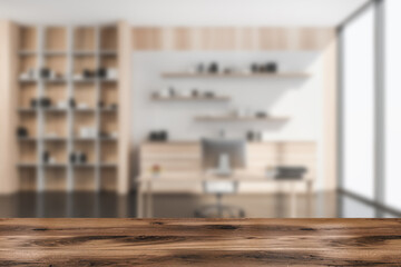 Wooden table with modern white wood manager office on the background © ImageFlow