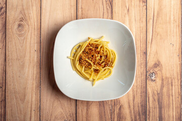 Bucatini spaghetti pasta aglio e olio with chili flakes parsley garlic . Concept classic Italian...