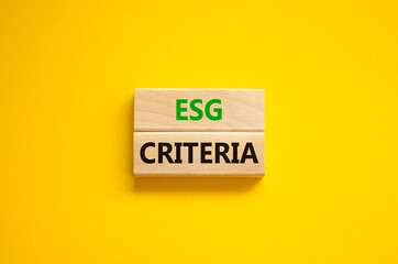 ESG environmental social governance criteria symbol. Concept words ESG criteria on blocks on a beautiful yellow background. Business, ESG environmental social governance criteria concept. Copy space.
