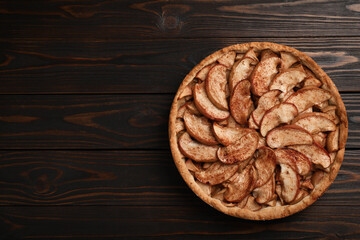 Delicious apple pie on wooden table, top view. Space for text