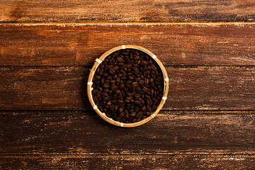 A basket of coffee beans on a wooden table
