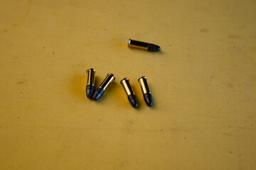 Five bullets on the table. Military ammunition