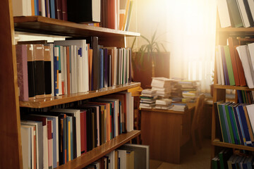 Collection of different books on shelves in library