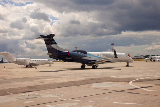 KYIV, UKRAINE - JULY 08, 2020: Plane Embraer ERJ-135BJ Legacy 600 Standing At The Airport. Clouds Sky. Airplane. Copy Space. Run Way.