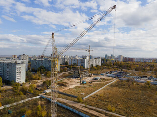 Fototapeta na wymiar A construction crane on a construction site. Top view. Aerial photography