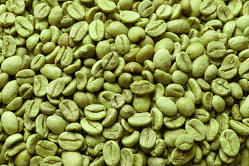 Many green coffee beans as background, top view