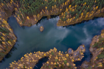 Aerial view of small lakes surrounded by autumn forest.
