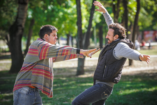 Nervous and upset man pushes another during aggressive quarrel conflict