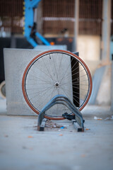 Stolen bicycle, chained front wheel locked. A single bicycle wheel on the street for theft.