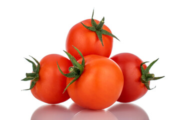 Several red organic tomatoes, close-up, isolated on white.